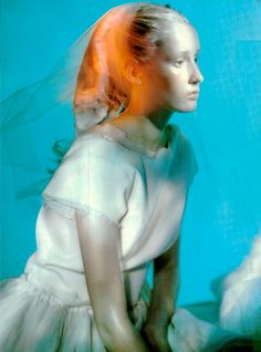 a woman in a white dress with orange hair