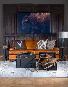 a living room filled with lots of different pieces of luggage on top of a rug