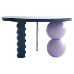 a table with two balls on it and a metal bar at the top that is curved