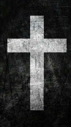 a white cross on a black background with the words jesus christ written in spanish and english