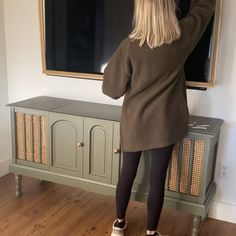 a woman standing in front of a chalkboard with her hands on the chalk board