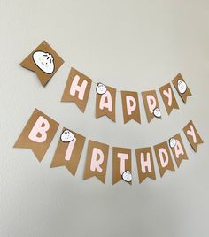 a happy birthday banner hanging on the wall