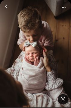 a woman holding a baby in her arms