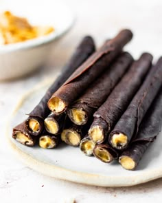 chocolate wrapped rolls on a plate with ingredients labeled