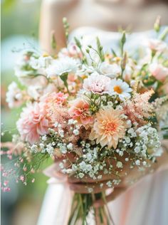 a woman holding a bouquet of flowers in her hands