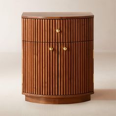 a wooden cabinet with brass knobs on the top and bottom, against a white background