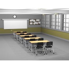 an empty classroom with desks and chairs in front of a whiteboard on the wall