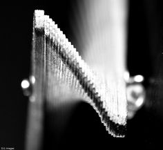 a black and white photo of a toothbrush with water droplets on the top of it