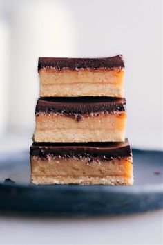 three pieces of cake sitting on top of a blue plate