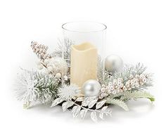 a candle and some christmas decorations on a white background