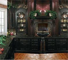 an ornate fireplace in the middle of a room with wooden cabinets and green plants around it