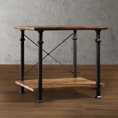 a wooden table with metal legs and a shelf on the bottom, against a gray wall