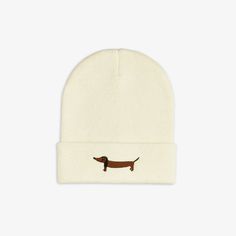 Knitted beanie with an embroidered Dog motif, made of 35 % organic wool and 65 % organic cotton. Designed with a folded brim. Playful White Beanie Cap, Playful Warm White Beanie, White Embroidered Beanie Hat, Beanie With Embroidered Logo, Winter Cotton Beanie With Embroidered Logo, Handmade Childrens Clothes, Embroidered Dog, Dog Motif, Gift Box Birthday