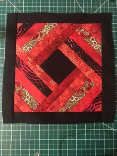 the square is made up of red and black fabric