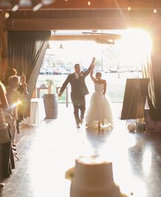 a bride and groom are walking down the aisle after their wedding ceremony at sundown