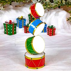 a group of christmas presents stacked on top of each other in front of a tree