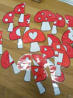 some red and white mushrooms cut out from paper