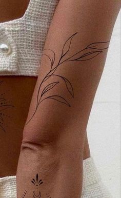 a woman's arm with tattoos on it, and an image of a flower