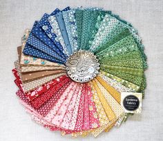 an assortment of different colored fabrics arranged in a circle