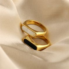 This elegant gold ring is a stunning piece of jewelry that is sure to impress.✨ Made from high-quality material, the ring has a sleek and sophisticated design that exudes style and refinement. The gold has a beautiful shine that catches the light and adds a touch of glamour to any outfit. Whether you choose a classic black or the white, this ring is sure to make a statement. Perfect for any special occasion, whether you're dressing up for a formal event or just want to add a touch of elegance to your everyday look! It's the perfect gift for someone special or a luxurious treat for yourself. Whether you're looking for a statement piece or a timeless classic, this elegant gold ring is sure to exceed your expectations. Size circumference: 5:    49.3 mm 6:    51.9 mm 7:    54.4 mm 8:    57 mm Baby Rings, Precious Rings, Shell Ring, Ringe Gold, Silver Jewelry Necklace, Golden Ring, Chunky Rings, Waterproof Jewelry