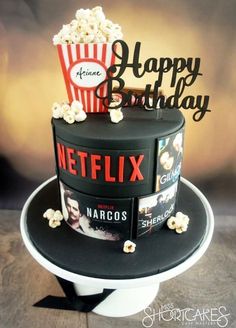 a birthday cake made to look like a bucket of popcorn