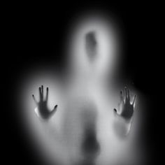 a ghostly figure with hands in the air