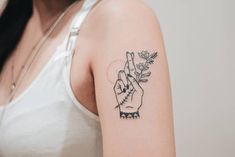 a woman with a small tattoo on her arm