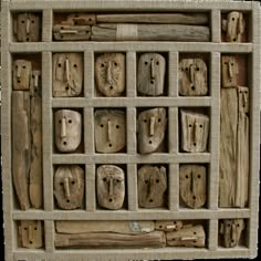 a wooden box filled with lots of different types of carved wood blocks and pieces of wood sticking out of it