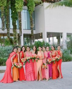 a group of women standing next to each other in front of a tall white building