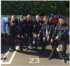 several police officers posing for a photo in the parking lot