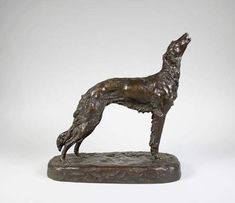 a bronze statue of a dog on a white background