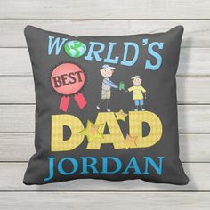 a black pillow with the words world's best dad and two children holding hands