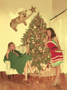 an old photo of two people sitting in front of a christmas tree talking on the phone