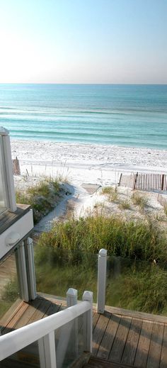 an ocean view from the balcony of a beach house