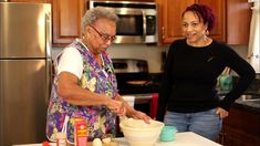 two women are in the kitchen preparing food