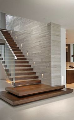 an open floor plan with stairs leading up to the kitchen