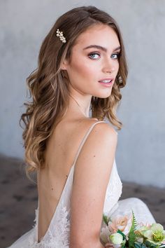 a woman in a wedding dress holding a bouquet