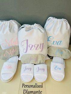 three personalized diapers are sitting next to each other on a table with a name tag