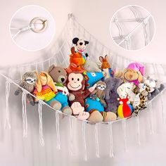 there are many stuffed animals in the hammock hanging on the wall with rings