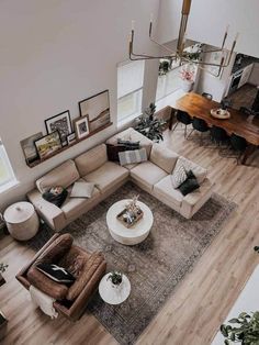 an overhead view of a living room with couches, tables and pictures on the wall