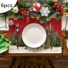 a place setting with christmas decorations on the table