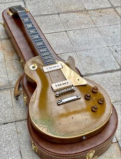 an old guitar case sitting on the ground