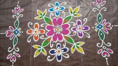 an artistically painted cloth with flowers and leaves on the side, is displayed in front of a white background