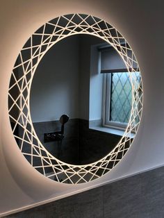 a circular mirror is lit up on the wall