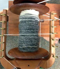 a spool of yarn sitting on top of a wooden chair