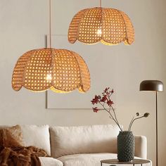 two lamps hanging from the ceiling above a couch