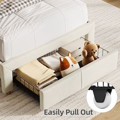 a white bed with two stuffed animals in the bottom drawer and an easy pull out storage bin