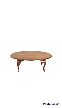 an oval wooden table sitting on top of a white background with the words photo room above it