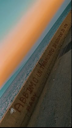 a man riding a skateboard down the side of a sidewalk next to the ocean