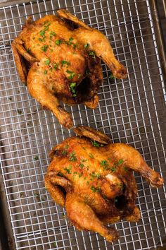 two whole chickens sitting on top of a cooling rack